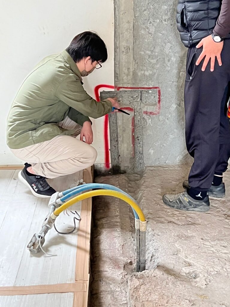 老屋翻新現場檢查管線位置，設計端與工班共同確認牆面水電走向