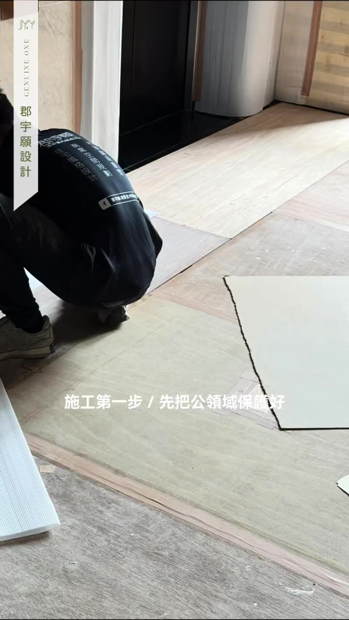 施工人員在室內地坪鋪設保護板材